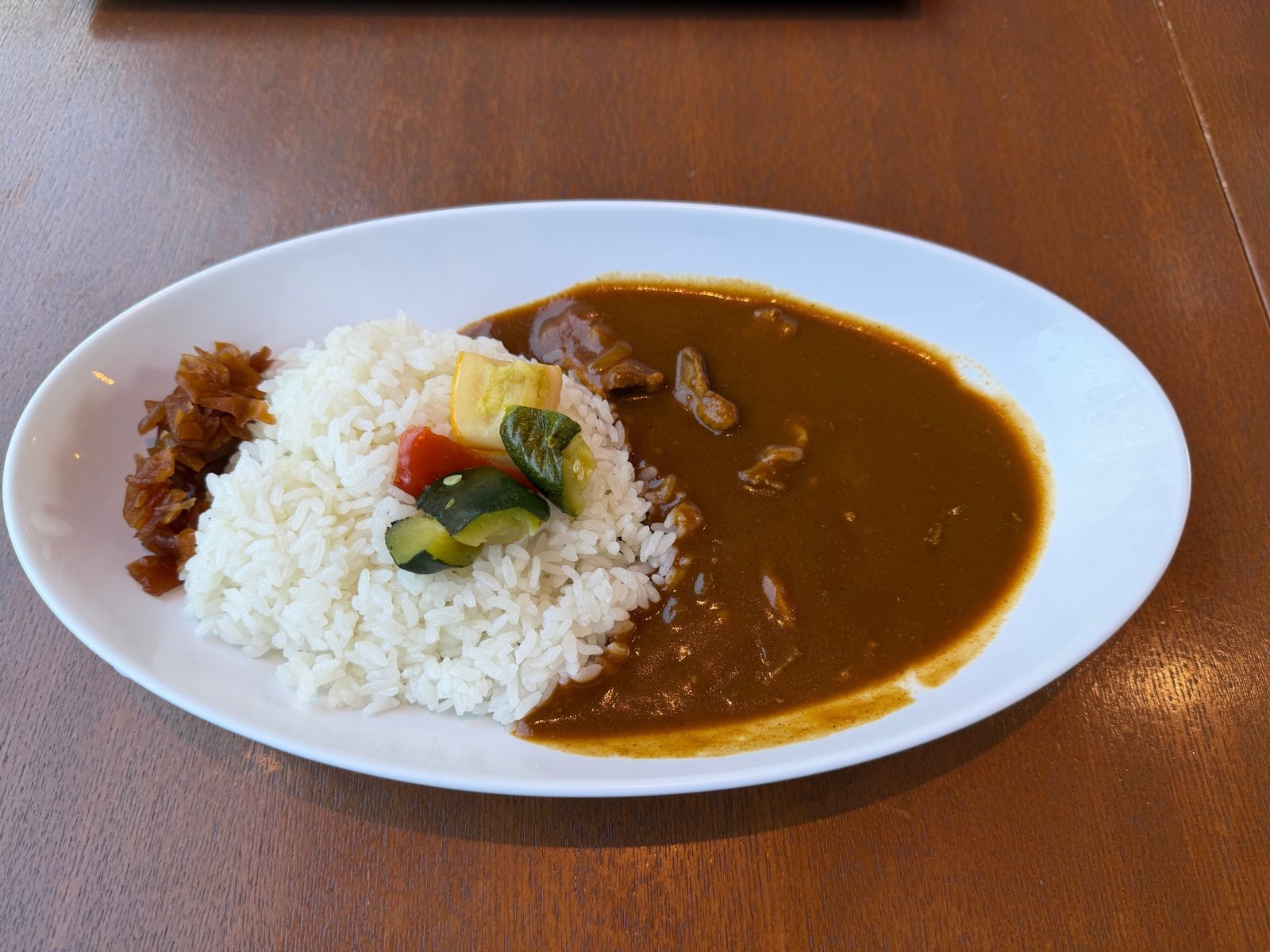 cafe Art（東京都美術館）のArt特製ビーフカレー。ご飯の上にズッキーニとパプリカ、横に刻んだ漬物